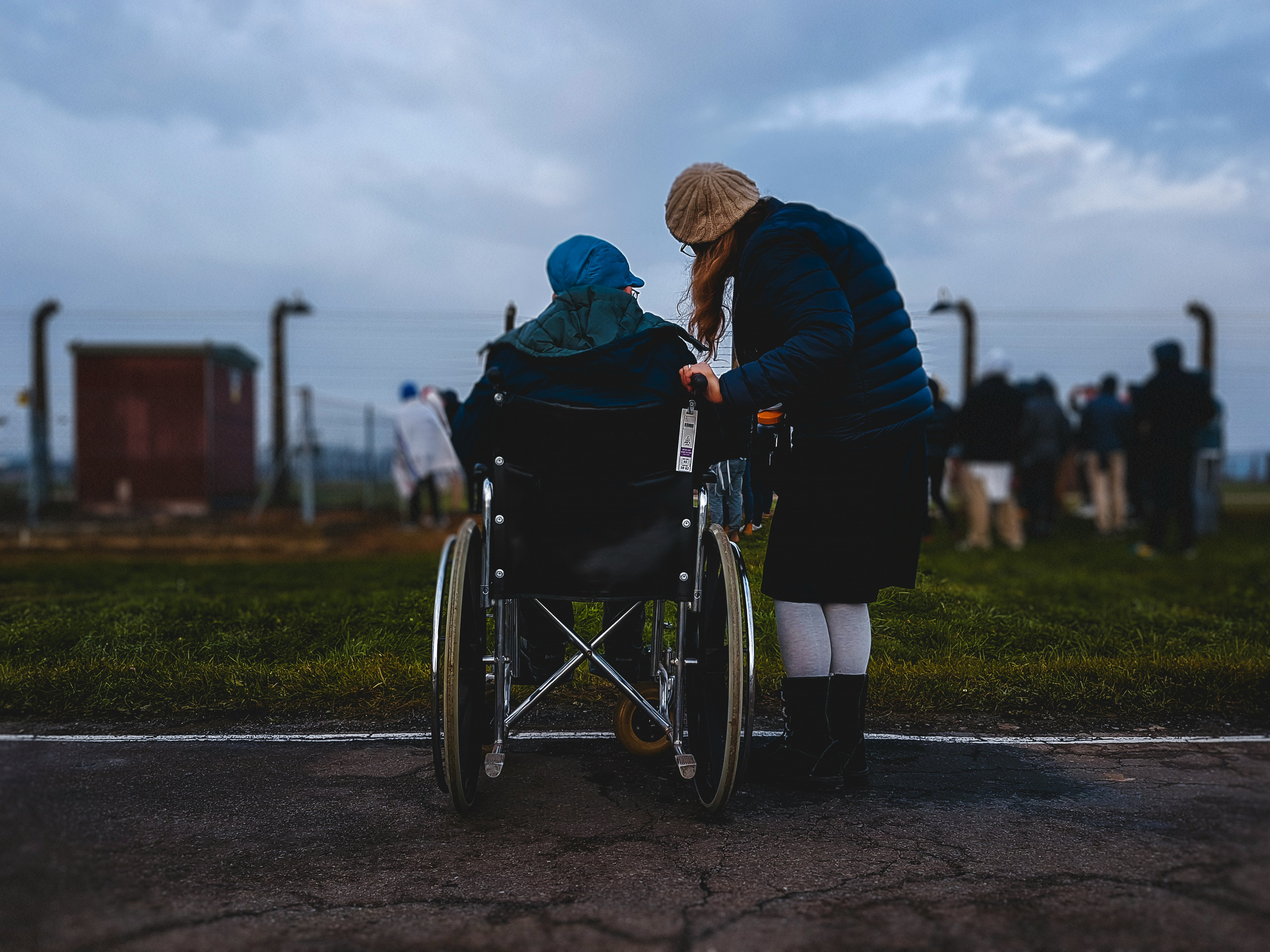 Caregiver assisting a person in a wheelchair